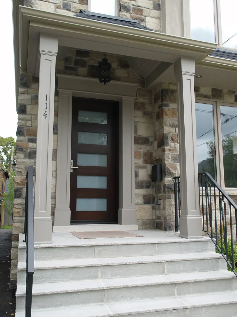 Home exterior clad in Castle stone veneer in Driftwood