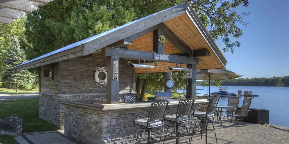 Outdoor kitchen island faced in Great Lakes stone veneer, Raven