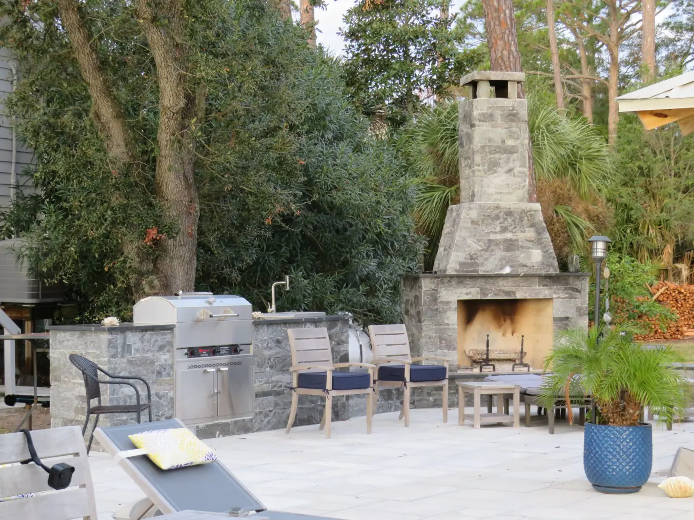 Patio with an outdoor kitchen and a stone outdoor fireplace