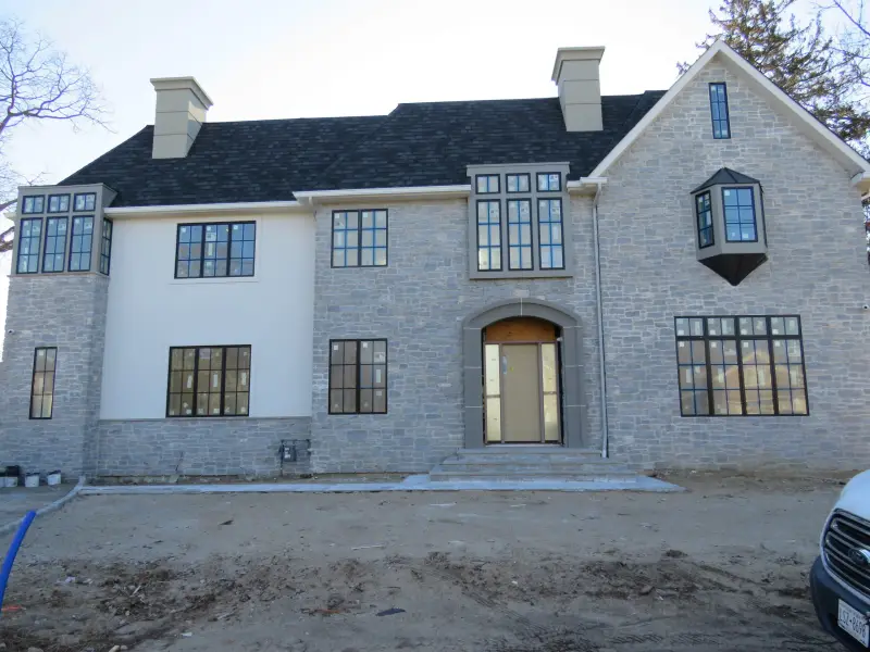 Manor-style home faced in coursed limestone
